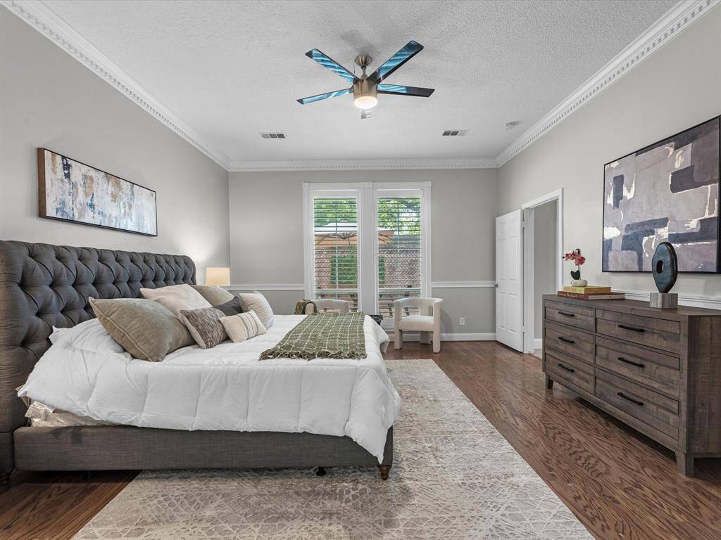 Notice the detail of the chair-rail, plantation shutters and ceiling molding.  The Primary Oasis overlooks the private front Courtyard.