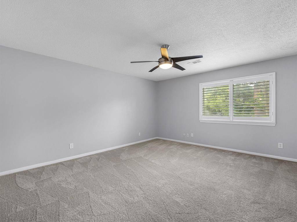 1 of 3 Secondary Bedrooms located upstairs with triple pane windows and plantation shutters.