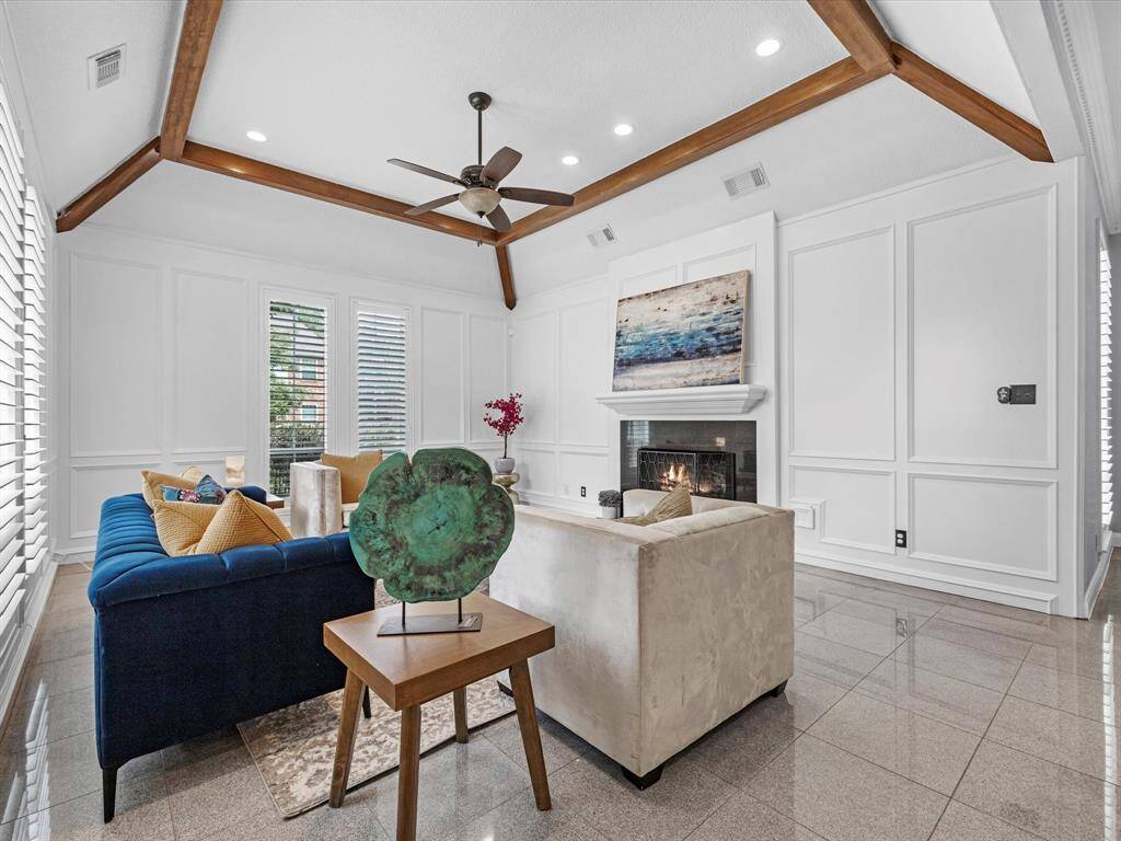 The fireplace provides a classic touch while the ceiling detail adds timeless sophistication.
