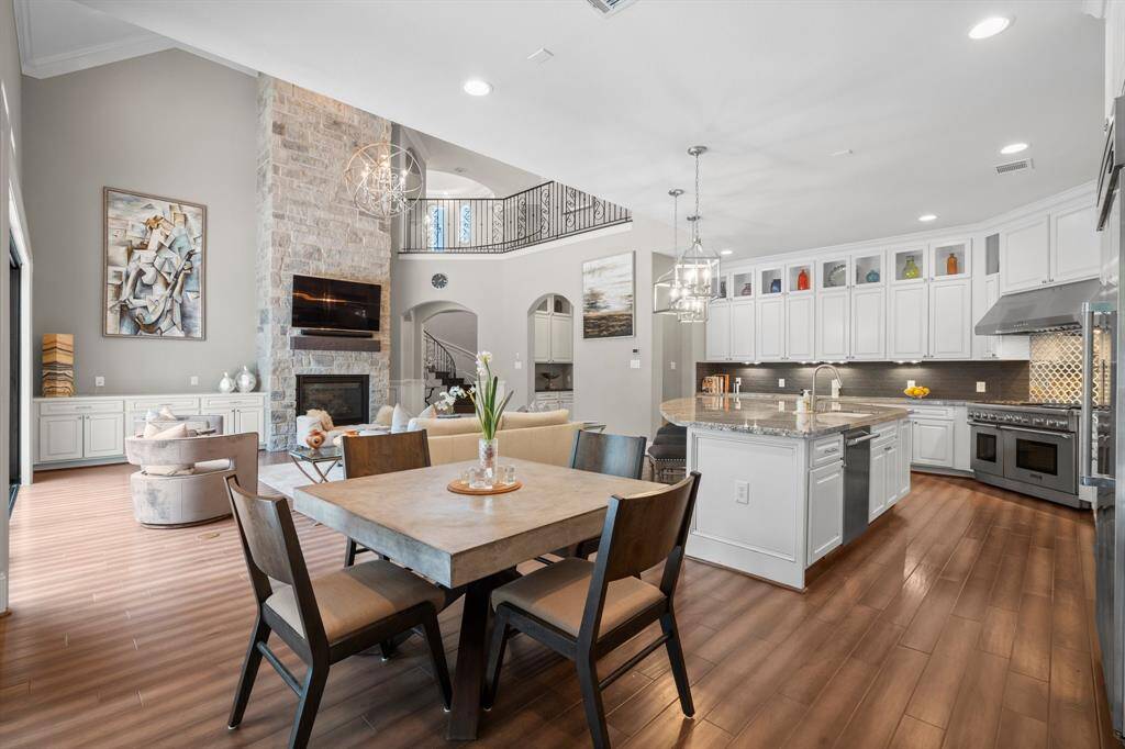 This gorgeous living and kitchen area is an entertainer’s dream! With an open floor plan, conversation flows effortlessly between the kitchen, den, and breakfast room—perfect for hosting or enjoying time with loved ones. Extra-large picture windows frame serene views, bringing in natural light and adding to the home’s inviting ambiance.