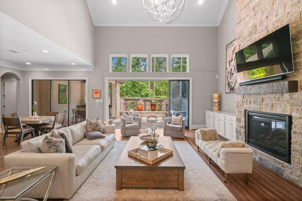 Relax in the warmth and comfort of this beautifully appointed Family Room, where a wall of retractable sliding glass doors with transom windows expand the outdoor entertaining and create a seamless flow to the outdoor living space. Designed with both style and function in mind, the room features wood-look tile flooring, recessed lighting, triple crown molding, 9” baseboards, and an elegant chandelier. Enjoy unobstructed views of the backyard patio while basking in abundant natural light.