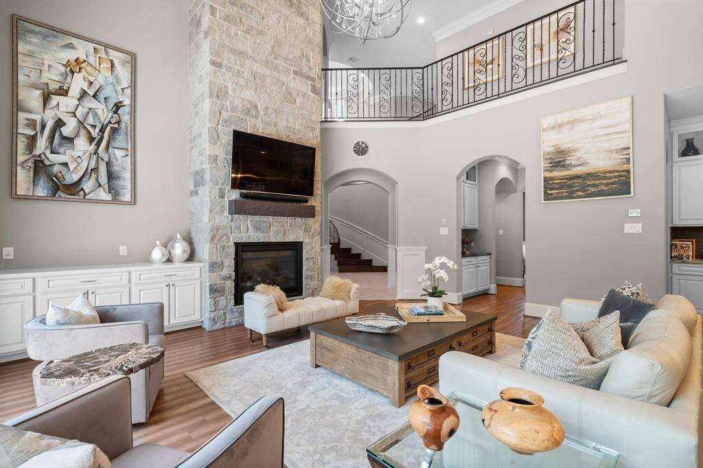 The heart of this inviting Family Room is the floor-to-ceiling stone fireplace with a rustic wood mantle and convenient gas starter and gas logs, offering both warmth and style. A custom built-in cabinet provides stylish, functional storage for media and electronics.