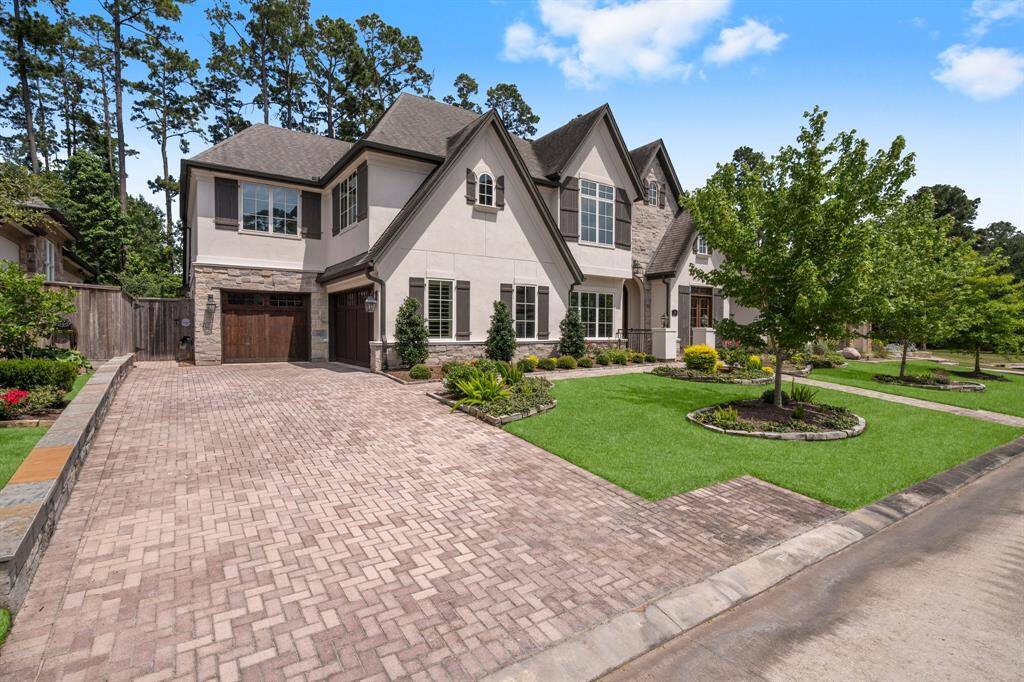13 Honey Daffodil Place offers timeless charm and modern convenience. From the intricate stone work, curved turret, contrasting wood shutters, and gorgeous landscaping, every detail adds to its impressive curb appeal. Inside, you'll find arched entryways, triple crown molding, 9” baseboards and 5” plantation shutters throughout,l and plenty of upgrades that make this home truly special. 3+ car garage with tons of storage & workshop. Home has 6 zone HVAC system & dual tankless water heaters.