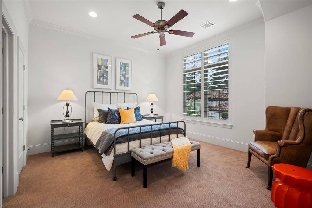 Three secondary bedrooms with their own en-suite baths are located on the second floor. This room features lush carpeting, recessed lighting, crown molding, large walk-in closet with built-in shelving, sunny double window with 5” plantation shutters, and ceiling fan.