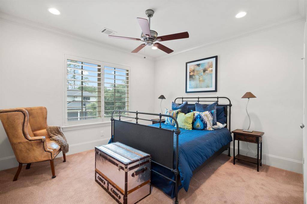 Another secondary bedroom offers lush carpeting, recessed lighting, crown molding, large walk-in closet with attic storage access, (attic runs across the entire upstairs and is fully floored) sunny double window with 5” plantation shutters, and ceiling fan.