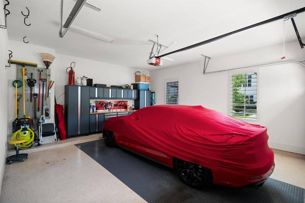 The spacious three-car garage (one 2-bay & one 1-bay) offers ample room for parking and storage, and includes a premium 10-piece NewAge storage system featuring heavy-duty, 18-gauge welded steel construction and powder-coated cabinets—ideal for organizing tools of all sizes. Durable epoxy flooring adds a sleek, easy-to-maintain finish that’s both chemical-resistant and visually appealing. The paver driveway completes the exterior with long-lasting durability, low maintenance, and timeless curb appeal.