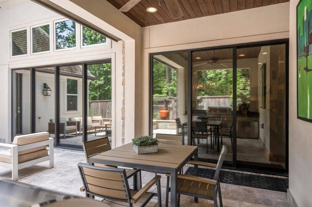 Experience seamless indoor-outdoor living with fully stackable glass doors that retract completely out of sight, effortlessly expanding your entertaining space from the covered porch to the patio. All house windows have Duralight window tint to increase energy efficiency, UV protection, reduce glare, and complement the home decor.