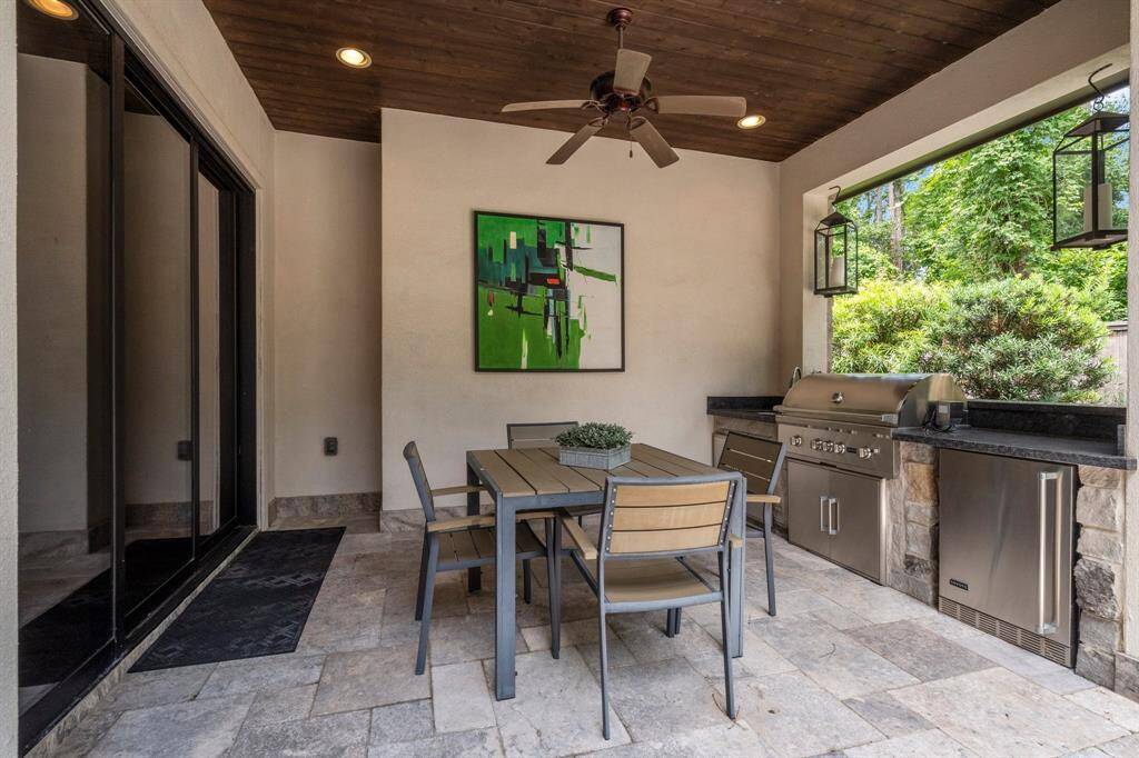 Elevate your outdoor entertaining with a fully equipped kitchen featuring premium Coyote appliances, including a professional-grade 4-burner grill and a built-in beverage refrigerator—perfect for hosting in style and comfort. The ceiling fan keeps you cool year-round.