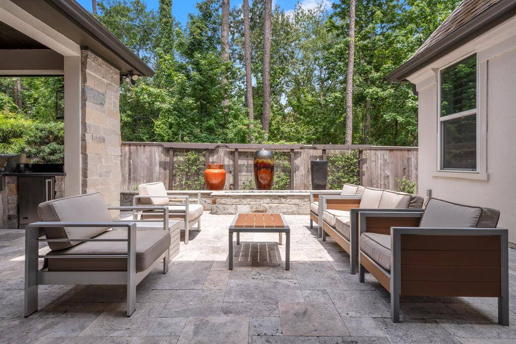 This custom-designed backyard, crafted by a landscape architect with entertaining in mind, showcases elegant travertine pavers, a stunning fire and waterfall feature, and beautifully manicured flower beds. Thoughtfully planned for visual impact and effortless maintenance, it’s the perfect blend of luxury and livability.