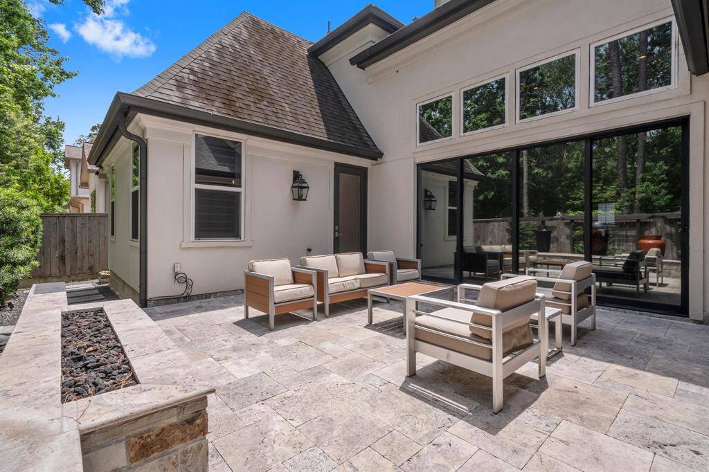 This home is equipped with full-perimeter gutters for efficient rainwater management, along with front and back irrigation systems to keep the landscape lush and vibrant. The backyard is thoughtfully designed to be both visually stunning and low-maintenance—offering beauty without the hassle.