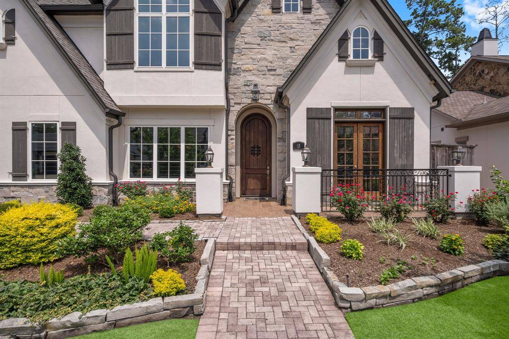 Luxury starts at the gorgeous covered front porch, featuring a stately 10 foot arched front door that makes a lasting first impression. Wood shutters, blooming landscaping, and detailed stonework complete the picture.  Inside, this custom home is packed with high-end details and upgrades at every turn, offering a perfect blend of elegance and comfort.