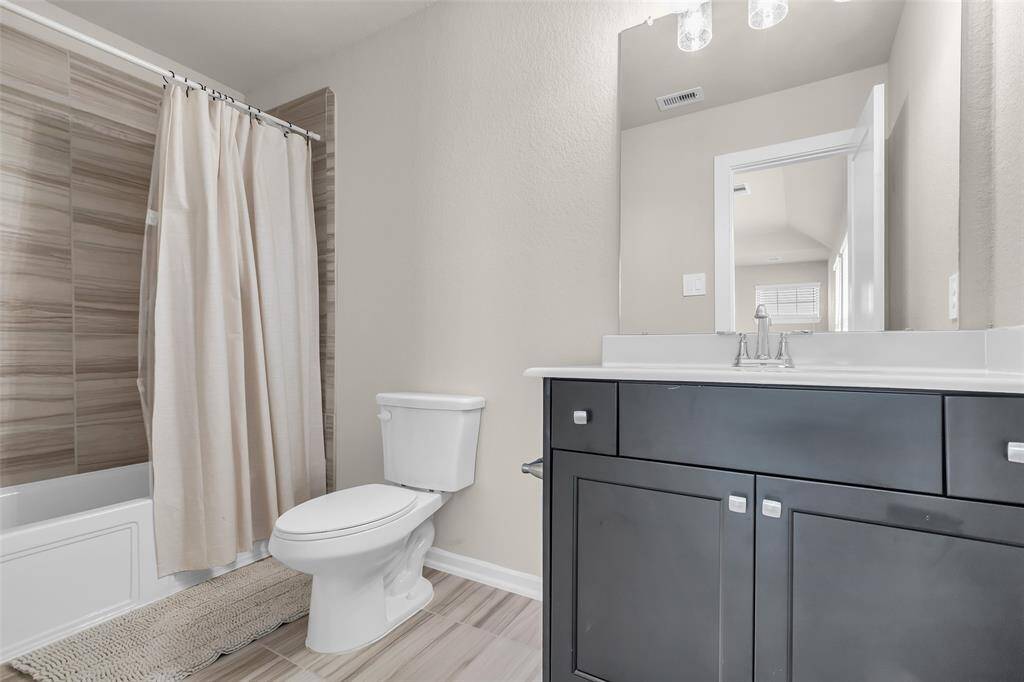 The bathroom features a convenient tub and shower combo, perfect for everyday use.