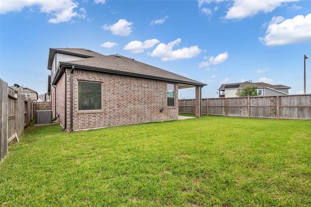 A view of this well-maintained home with a spacious backyard—ready for outdoor living, play, or gatherings.