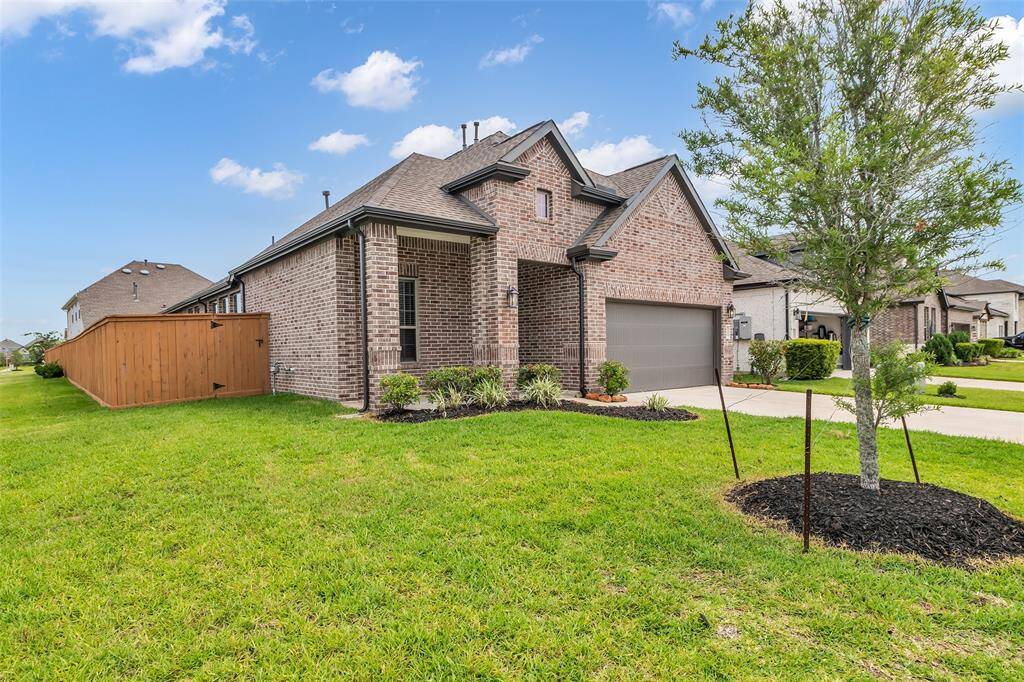 The front lawn features a private driveway and eye-catching curb appeal, creating a strong first impression.