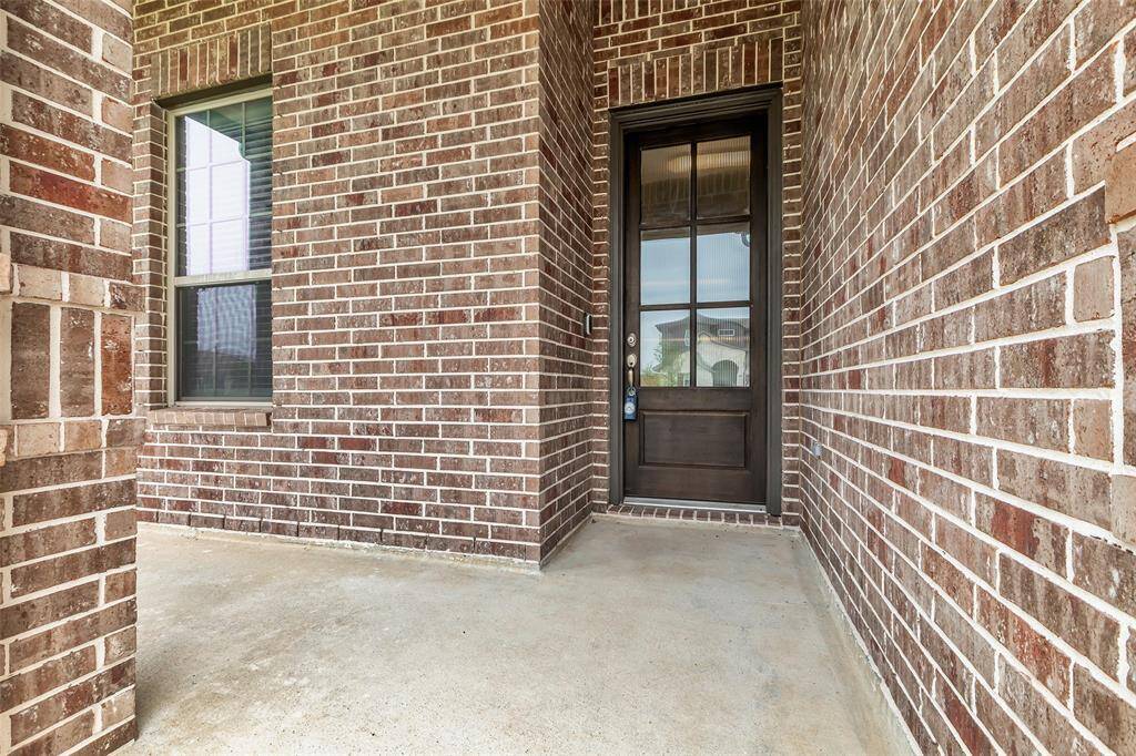 The front entrance showcases a timeless brick exterior with a clean, inviting design that sets the tone for the rest of the home.