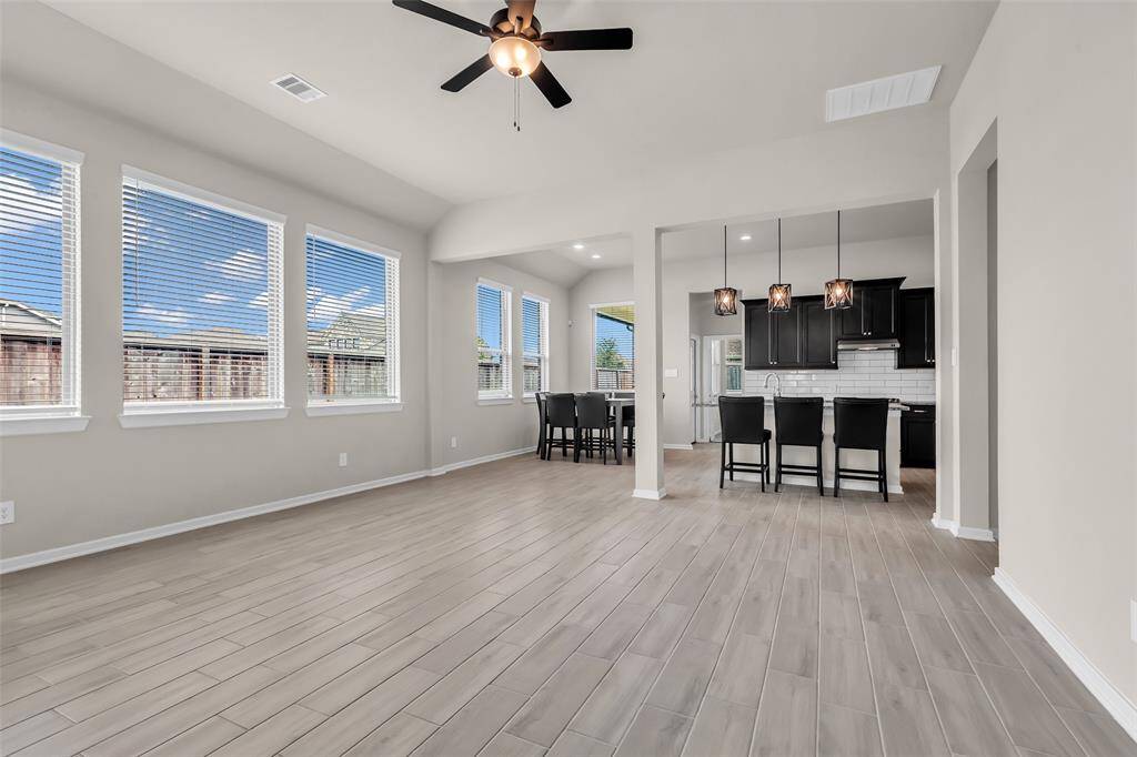 The open layout connects the living room, kitchen, and dining area, creating a spacious and practical setup that's great for everyday living and entertaining.