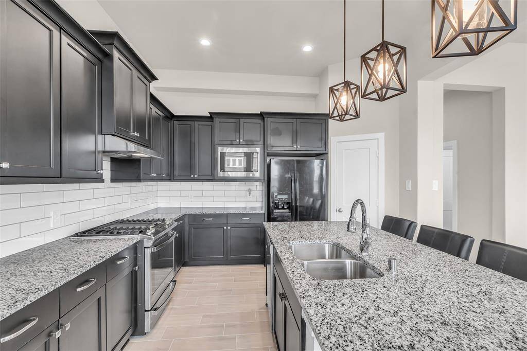 The kitchen is equipped with stainless steel appliances, granite countertops, and ample cabinet space for all your storage needs.