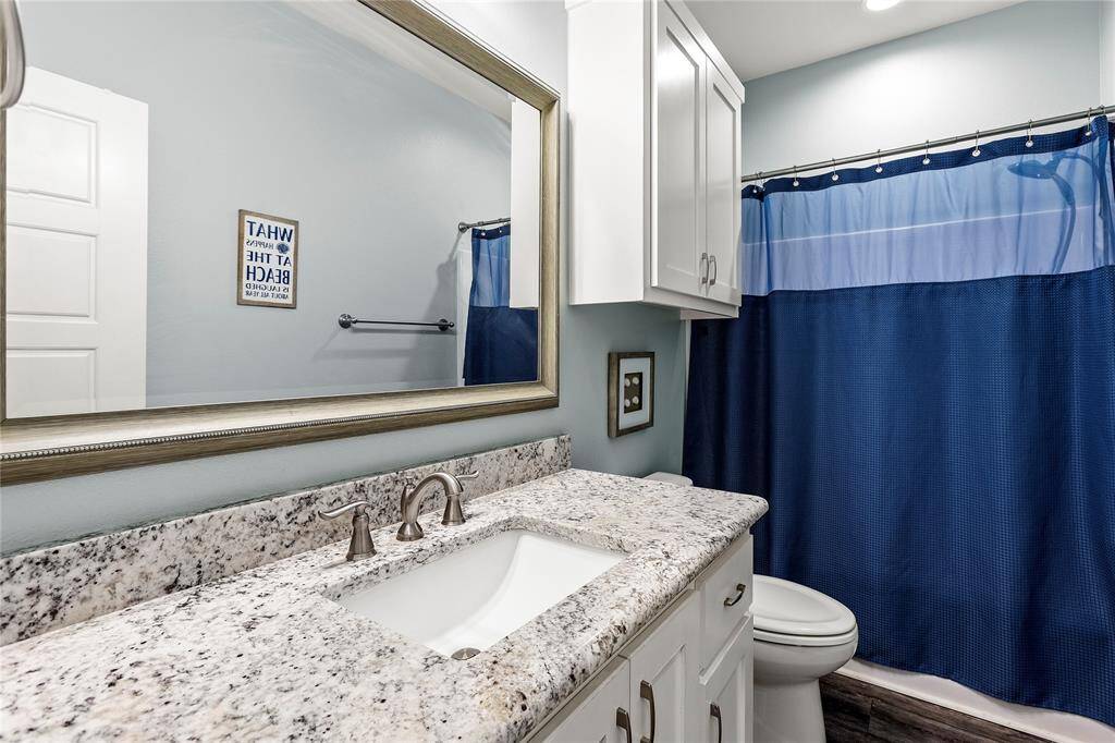 Bath 1: Hallway bathroom is shared by Bedrooms 1 and 4