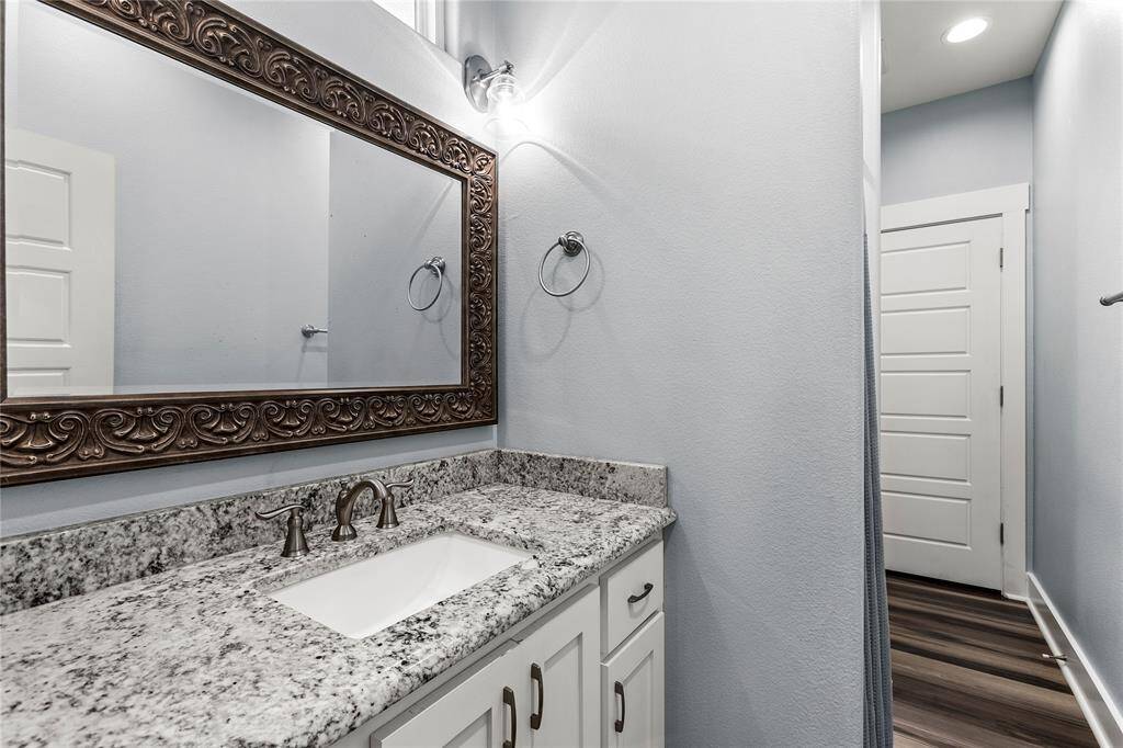 Bath 3: Primary bath features granite countertops