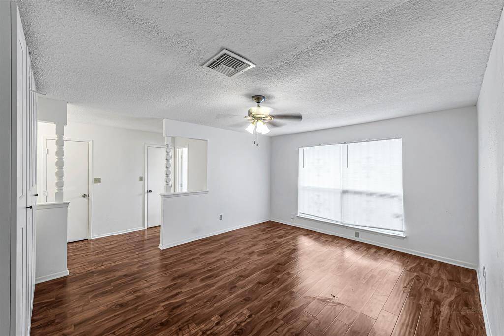 Spacious Primary Bedroom with built in wardrobes and view into vanity space.