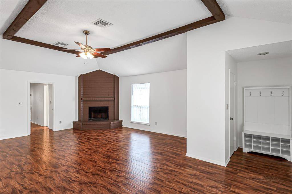Spacious family room with ceiling fan.