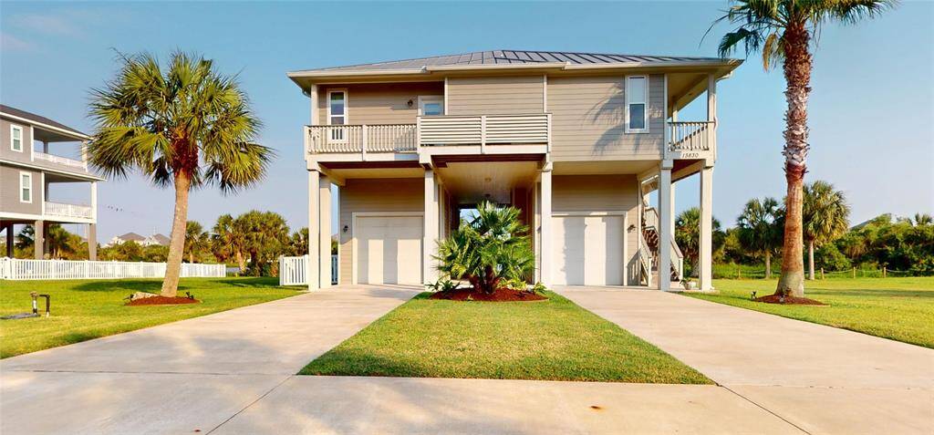 Front of the house features well manicured landscaping! Features a private deck for the primary bedroom! Two oversized garages. Built to last with oversized 12" pilings!