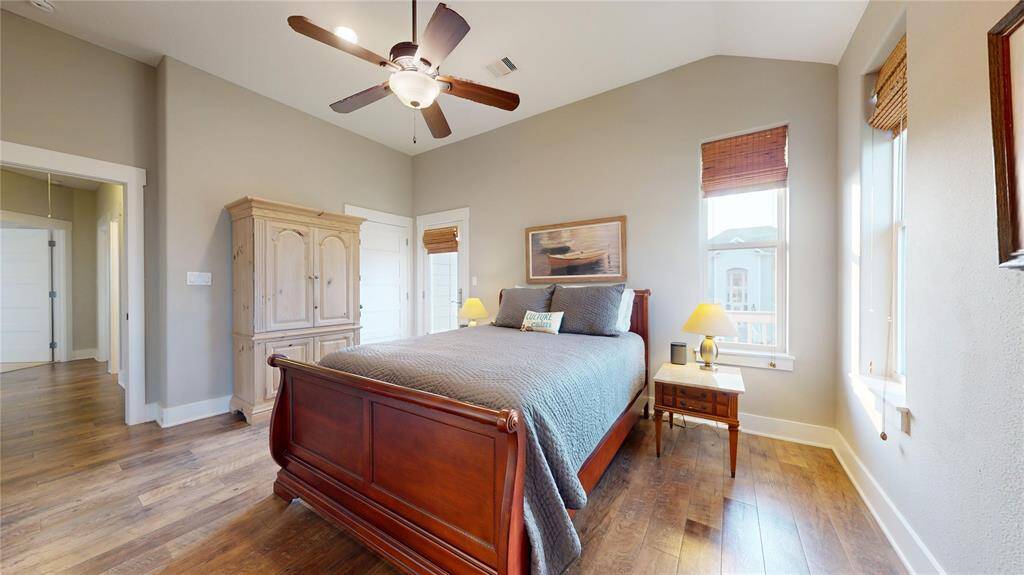 Primary bedroom with walk in closet, private balcony, and en suite bathroom