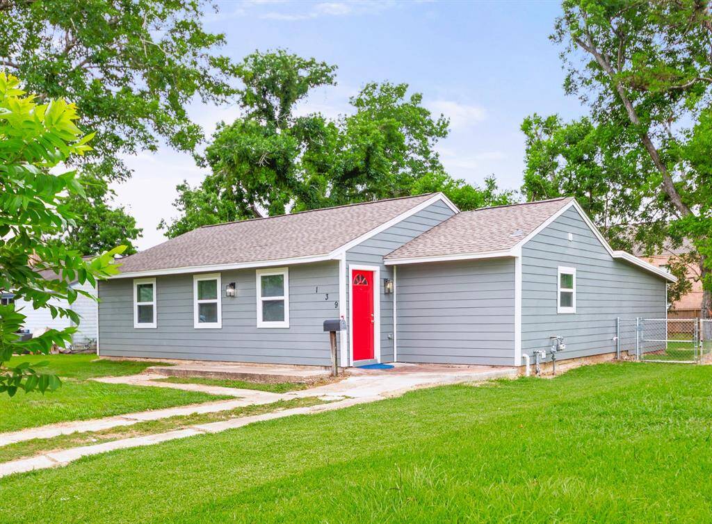This charming well-maintained home is surrounded by mature trees, offering a welcoming curb appeal