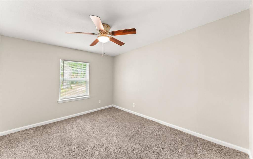 Bright and inviting fourth bedroom featuring a ceiling fan and plush carpeting, perfect for comfort and relaxation