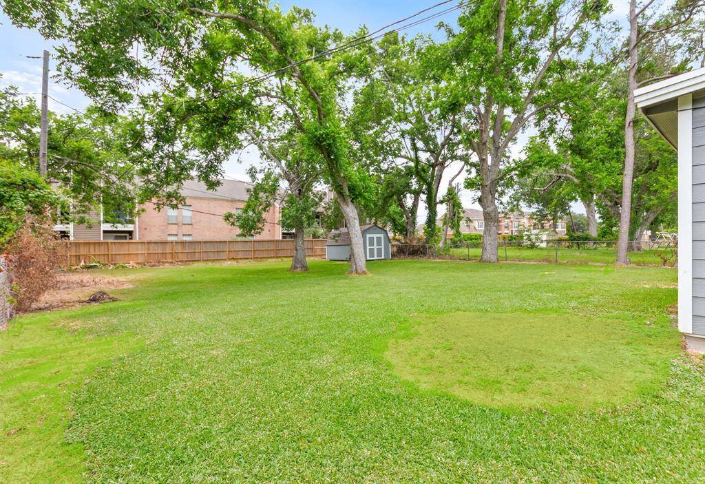 Expansive backyard shaded by mature trees