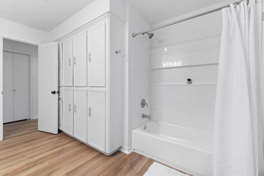 New tub surround and built in cabinets offer additional storage space.