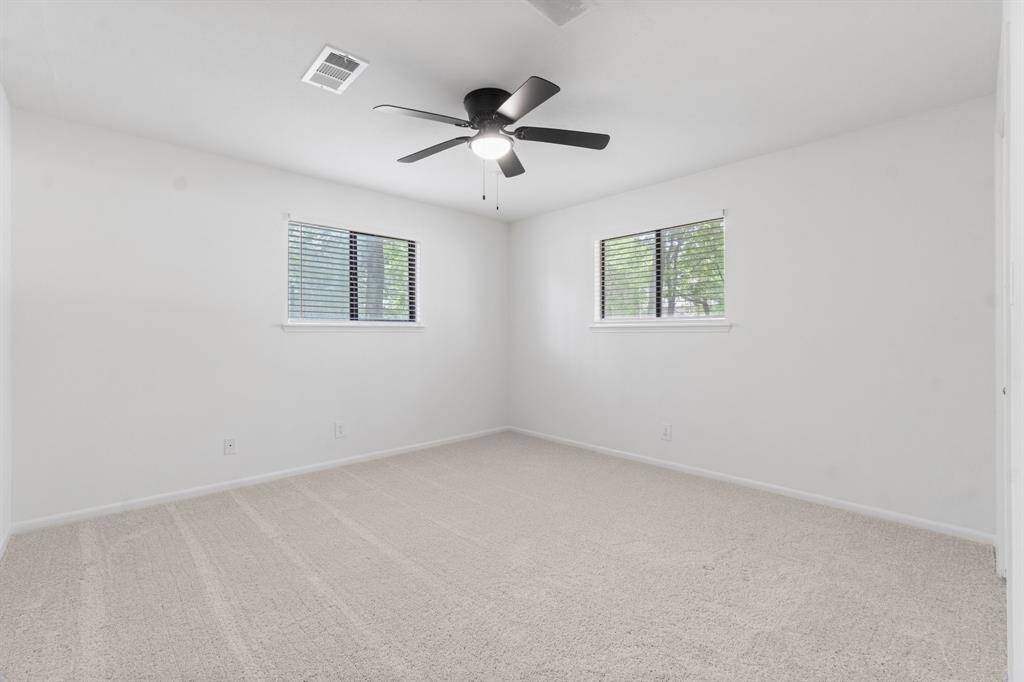 Primary bedroom located at the back of the home has two windows overlooking the backyard.