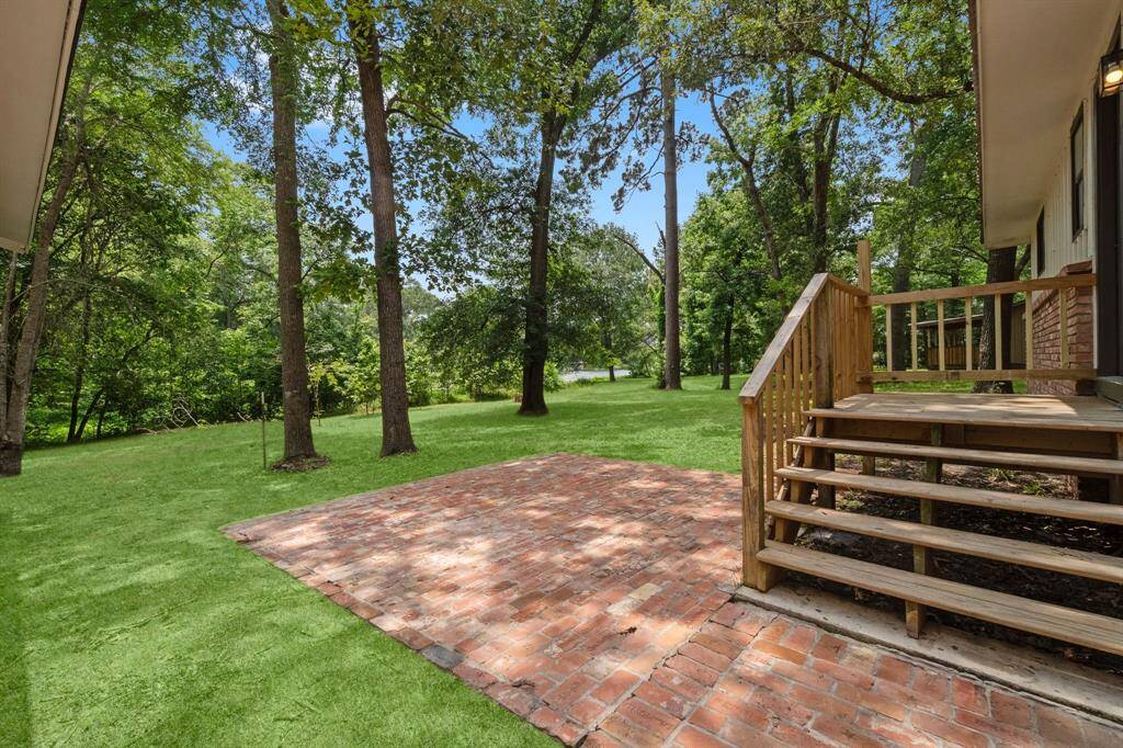 Step outside into your very own backyard oasis by the lake! Brick patio offers a space for your outdoor furniture.