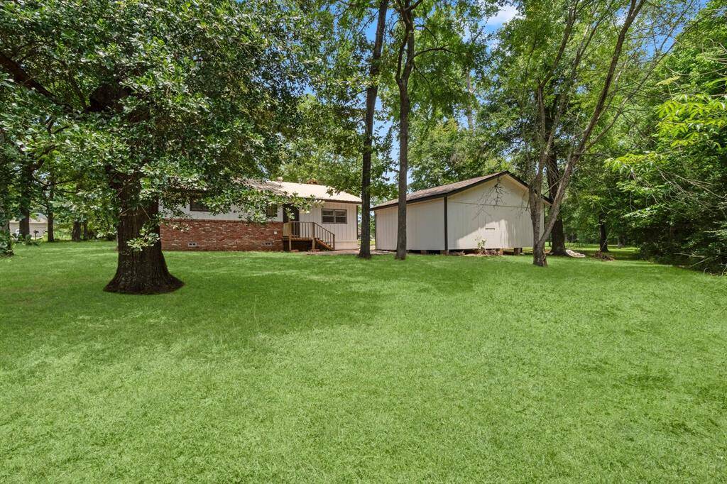 Another view of the property facing the back of the home and shed.