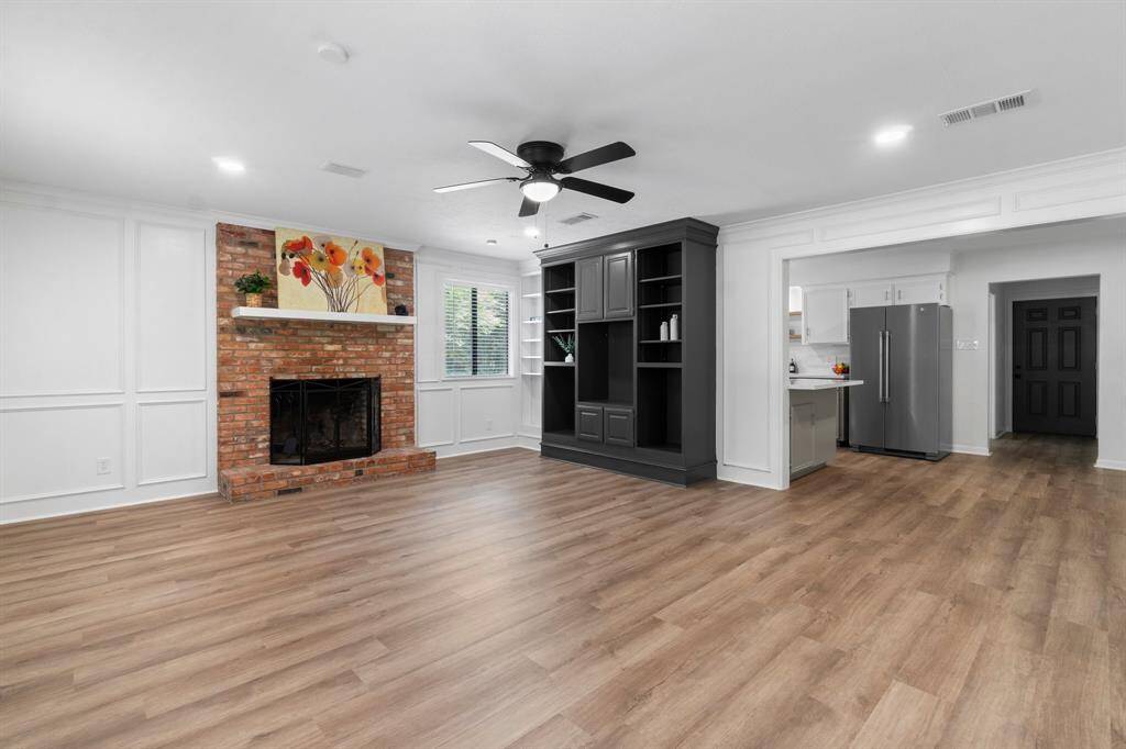 Recessed lighting & large windows bring natural light into this space.