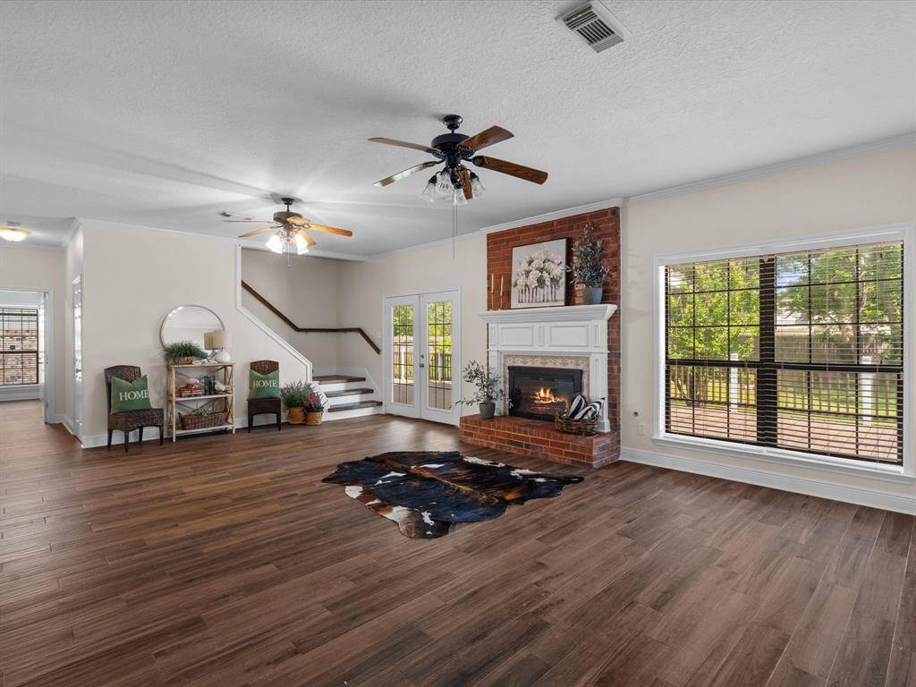 Relax in open concept living room, with abundance of natural light, French doors open open to huge patio, wooded lot and manicured yard and beds. Porcelain Wood like floors throughout the lower level, and staircase, wow! this 3900 sq ft floor plan.