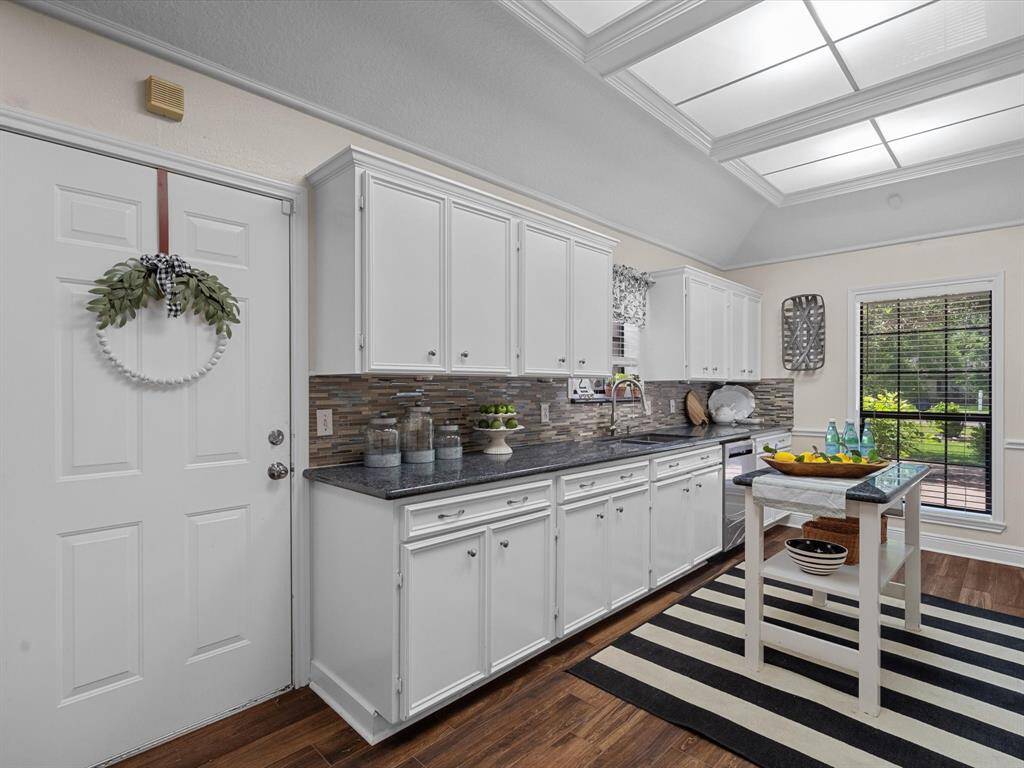A chiefs delight, A modern kitchen with lots of cabinets, walk in pantry, removable island, dual ovens, dishwasher, and designer glass back splash. If that isnt enough, enjoy custom lighting combined with natural light and the porcelain wood like floors.