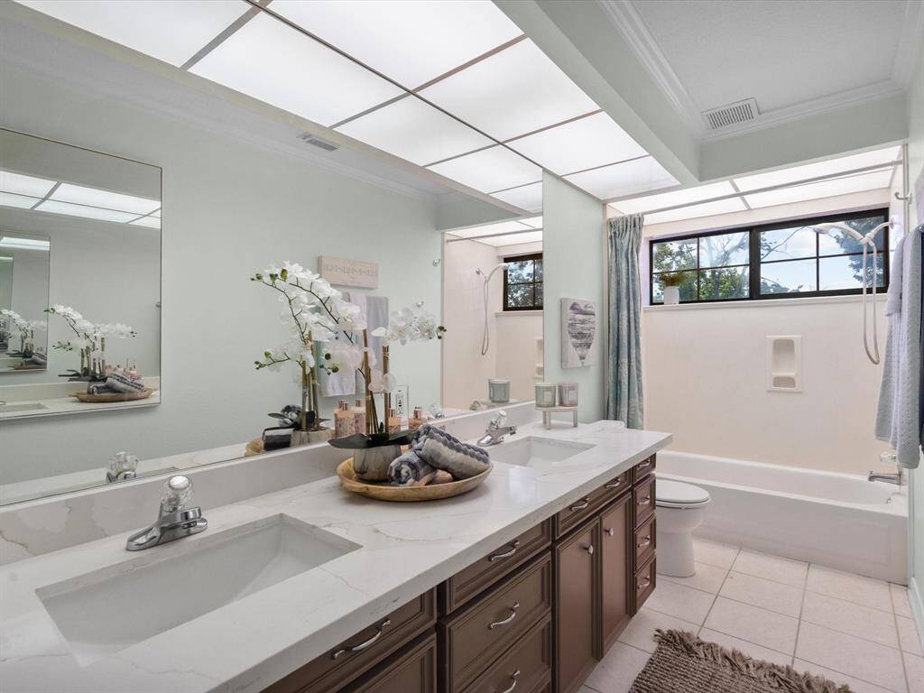 Second floor bathrooms, features quartz counters, dual sinks, soaking tub & shower. Lots of lighting.