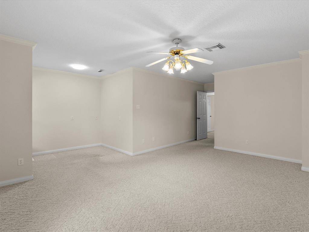 2nd floor bedroom with versatile sitting area, has multiple entry ways, recessed lighting and ceiling fans.