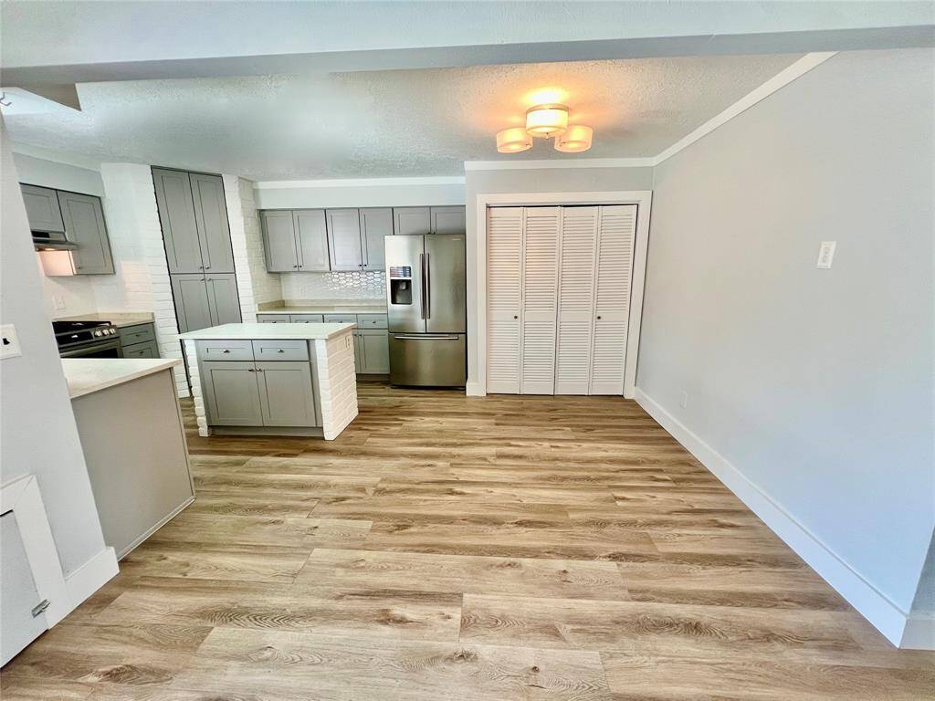 View of kitchen layout with laundry room on right.