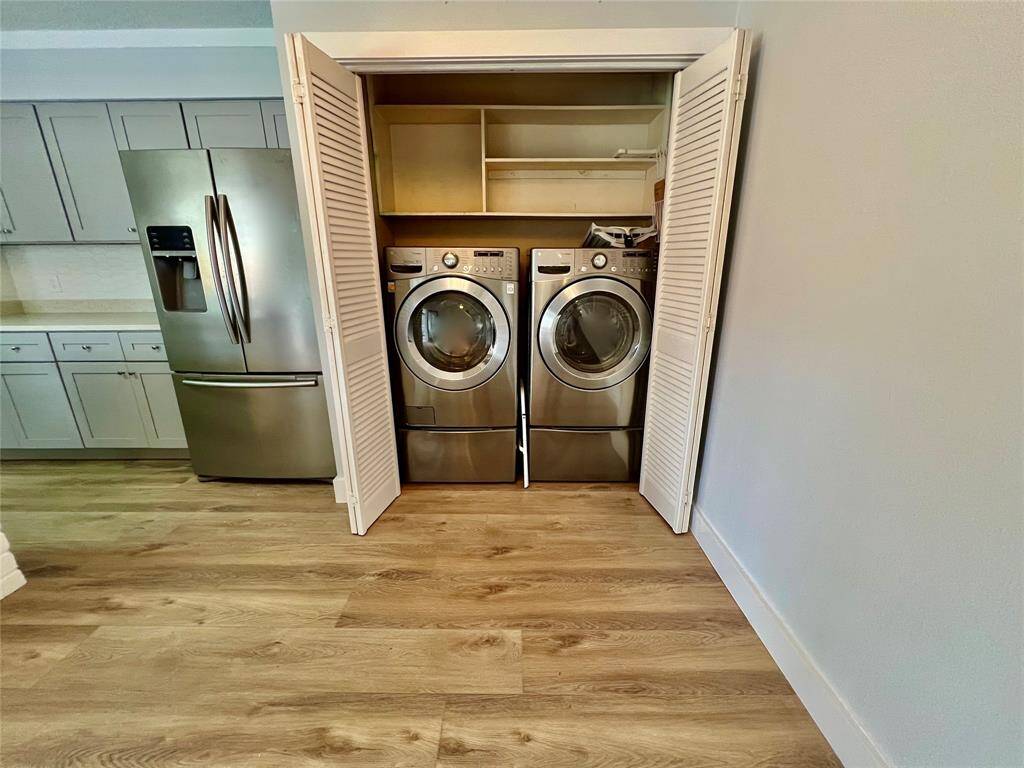 Full-size, front-loading washer and dryer on pedestals and stainless refrigerator INCLUDED.