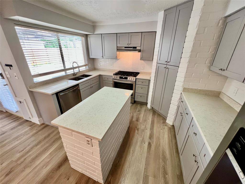 All new kitchen cabinetry with soft-close features. Nice brick accents around island and cabinetry.