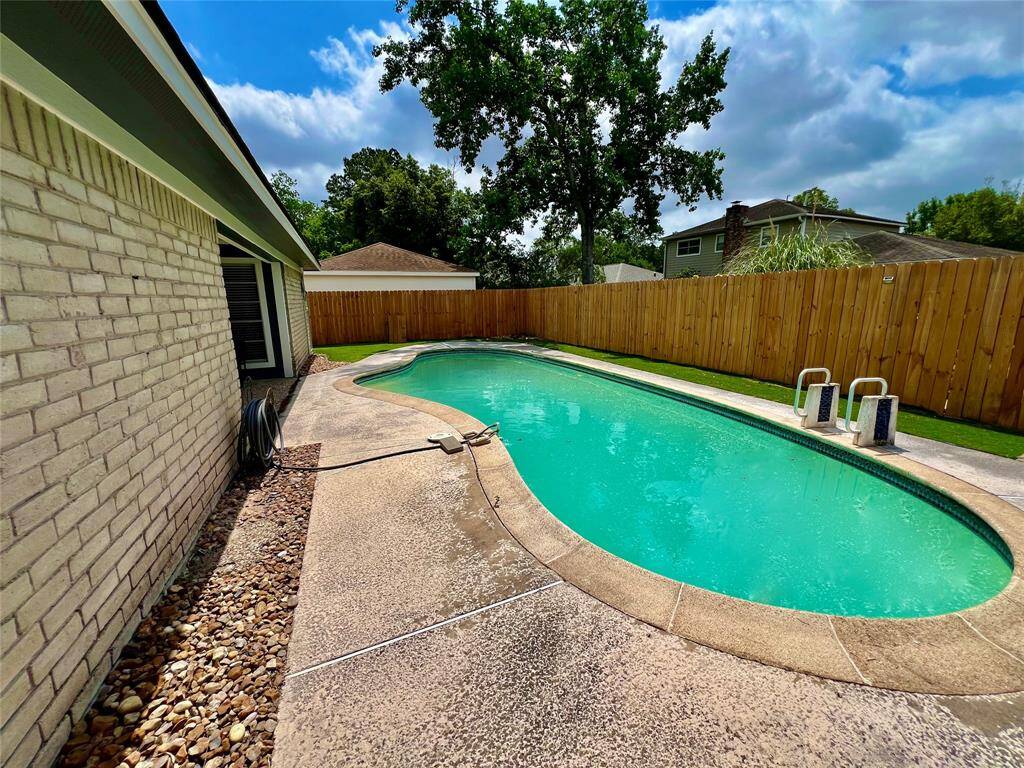 Alternate view of backyard with recent fencing.