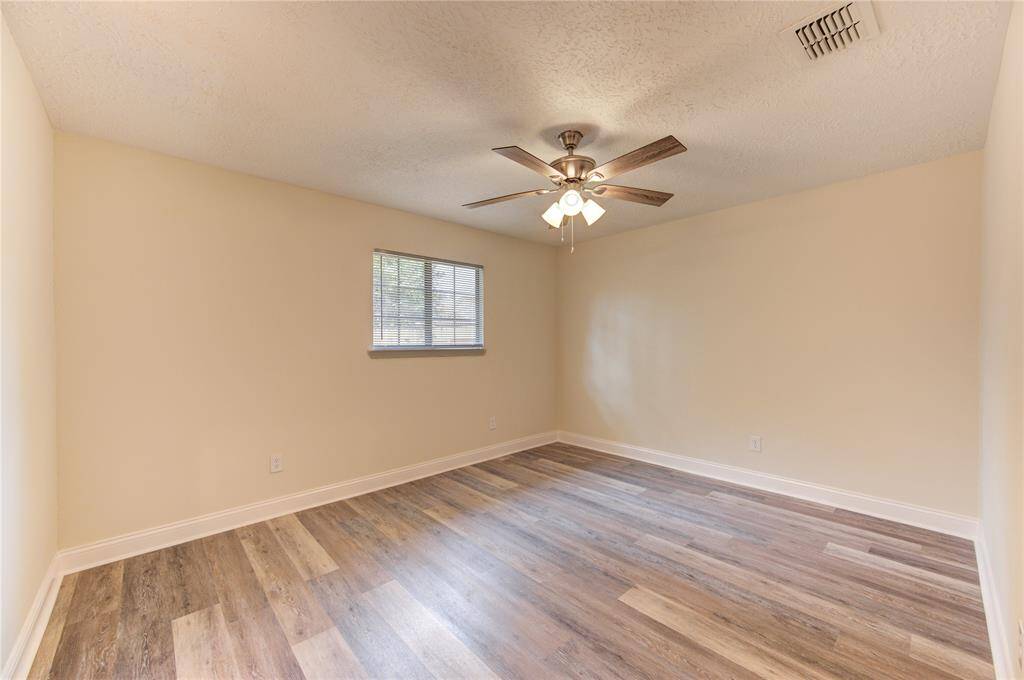 Primary Bedroom.  All bedrooms have blinds and ceiling fans!