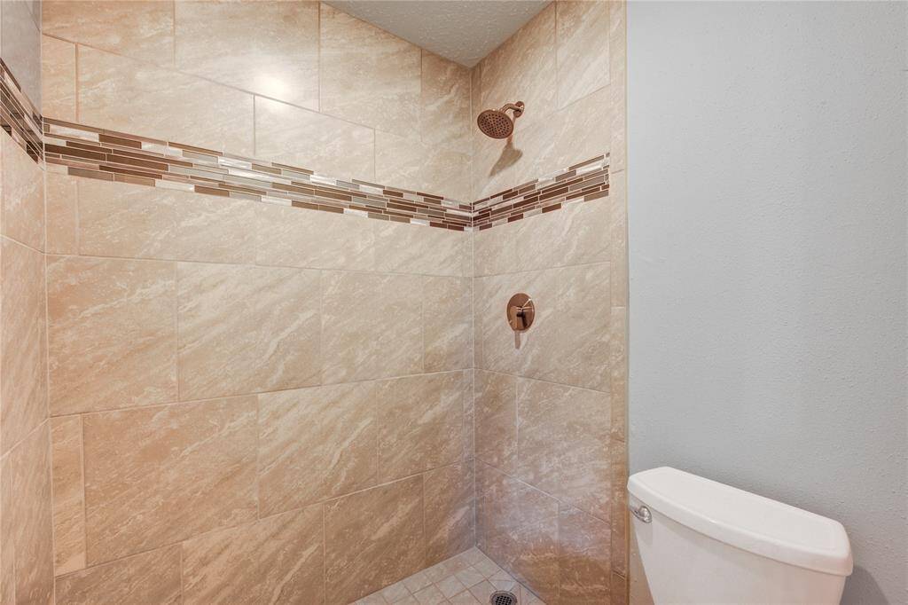 The beautifully new shower has glass mosaic details and new LED lighting.
