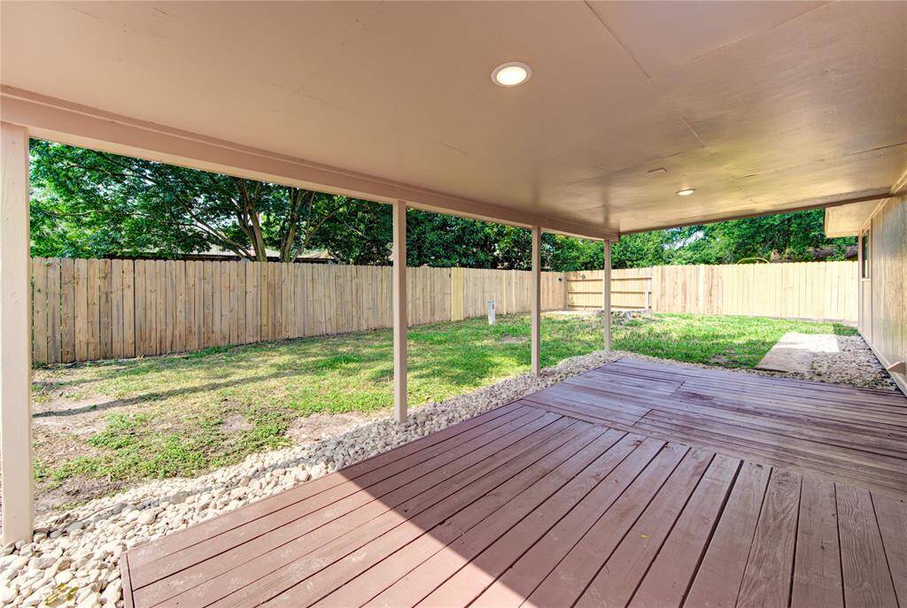 THe large covered back patio and wood deck are so nice to have on hot Houston days!