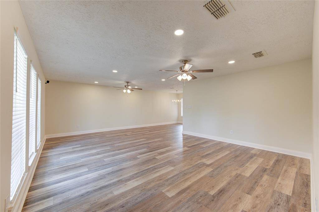 Inside you will notice the large family room with all new flooring, new LED recessed lighting, new ceiling fans, wide-format baseboards and fresh paint!