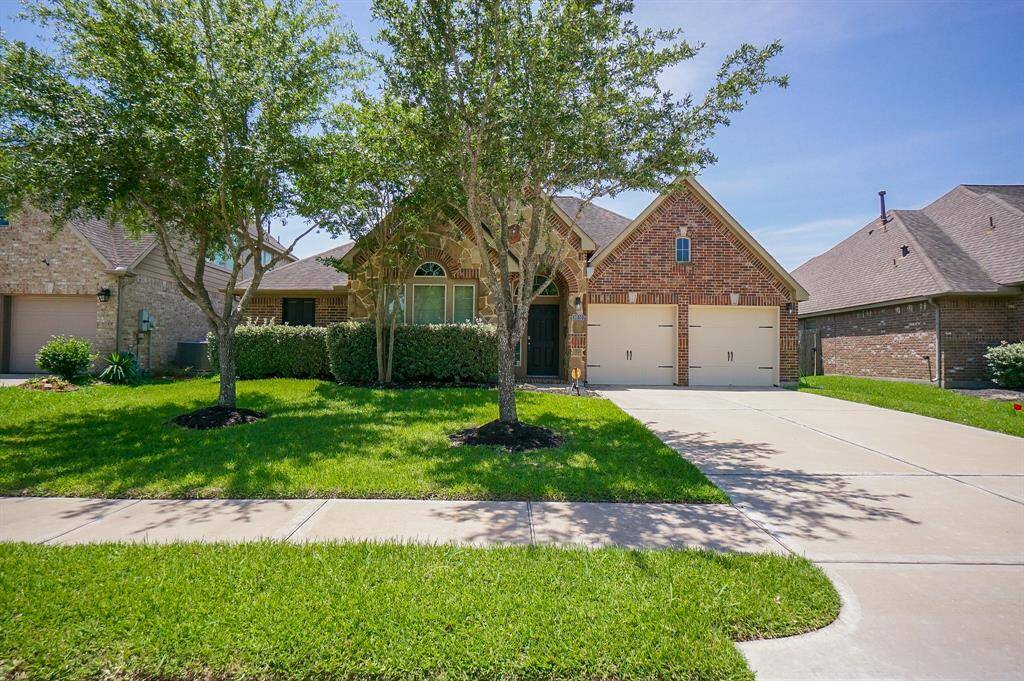 Don't let this one slip by! This bright, single family, brick/stone RENTAL is located at 14110 Green Thicket Drive, Pearland, TX, in the master planned Shadow Creek community. Carefully manicured, both inside and out, the home features 4 bedrooms, 2 full baths and occupies a 7,147 square-foot lot with 2,395 square-feet of lush interior living space. Seen here is the pristine driveway, below 2-attached garages.