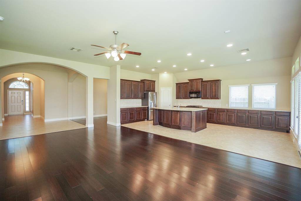 Huge, wide open, airy space is yours to claim and utilize in ways that best fit your lifestyle! Note the large double windows over gorgeous cabinetry, up right.