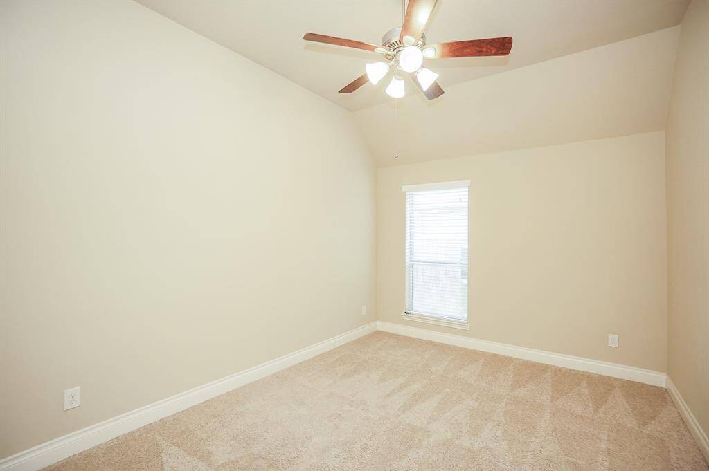 Peaceful light walls and new carpeting fill this spacious secondary bedroom.